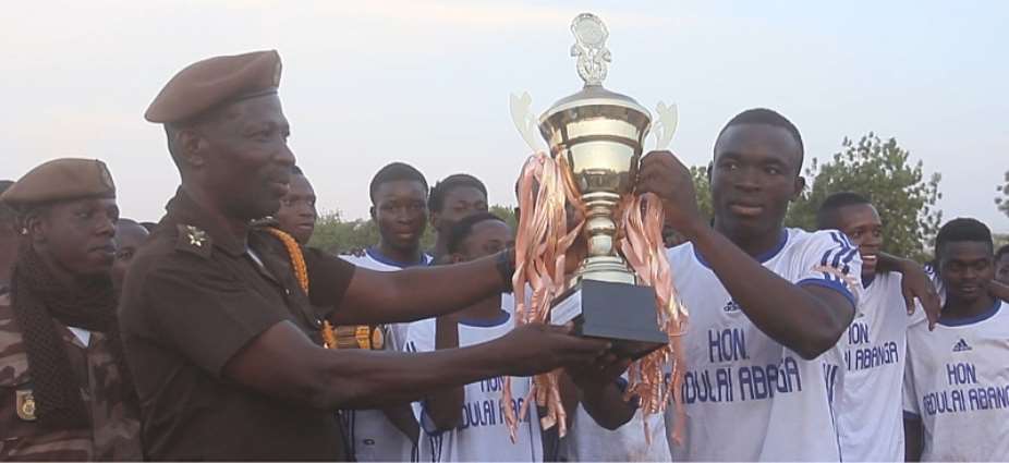 Zawse FC team elder receiving the trophy