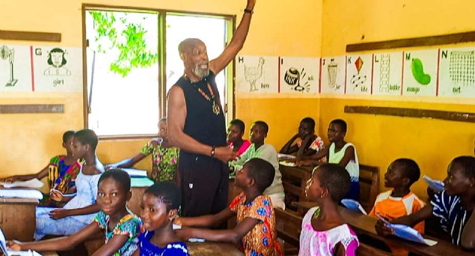 Baba George teaching children of Bakpe music