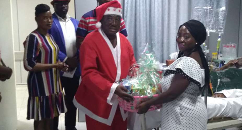 Captain Duah rtd presents a gift to a relative of a veteran