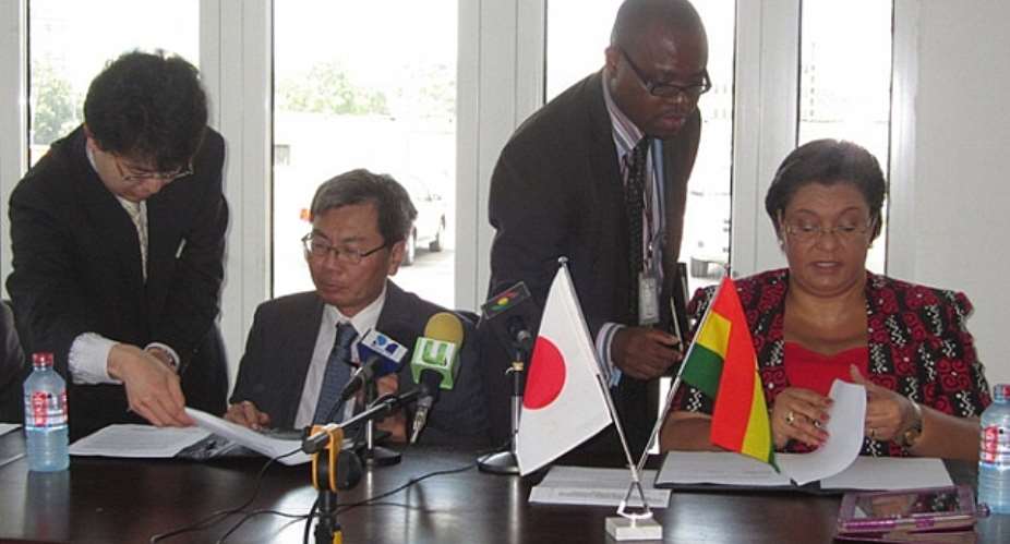 Japanese Ambassador Naoto Nikai and Ghanas Minister for Foreign Affairs, Hon. Hanna Tetteh signing the grant agreement