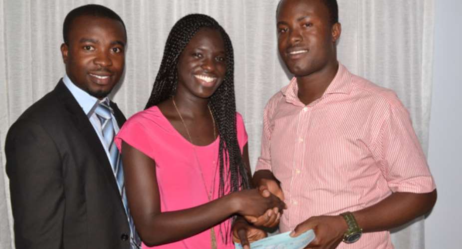 Adwoa Akor, Senior Art Director (middle) presenting the cheque to Jeremiah Quarshie (right). Looking on is Matthew Ansah, a Senior Account Manager at Rezultz