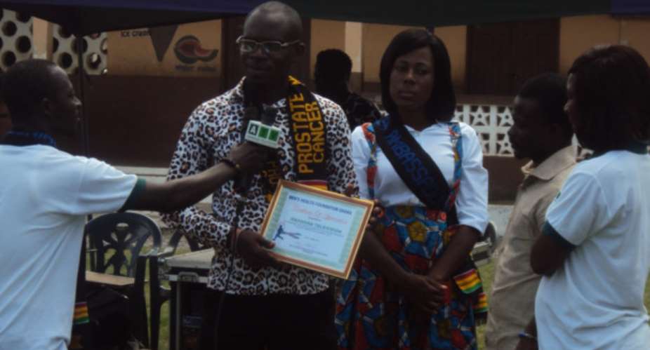Dr. Raphael Nyarkotey Obu 2nd from Left presenting the certificate of appreciation to the channel manager of ATV-Henrietta Adom1st from right
