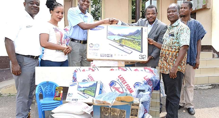 Mr. Emmanuel Baidoo, Senior Manager- Sustainability  Staff Of Iduapriem Mine Handing Over Items For The Best Woman Farmer For The 2015 National Farmers Day Celebration To Mr. Peter Thompson, Coordinating Director Of Tarkwa- Nsuaem Municipal Assembly