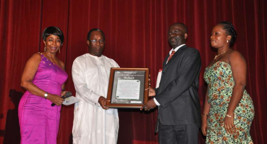 Dr. Cornelius Gligui receiving the award from Prof. Nii Otu Nartey, former C.E.O Korle-Bu Teaching Hospital.