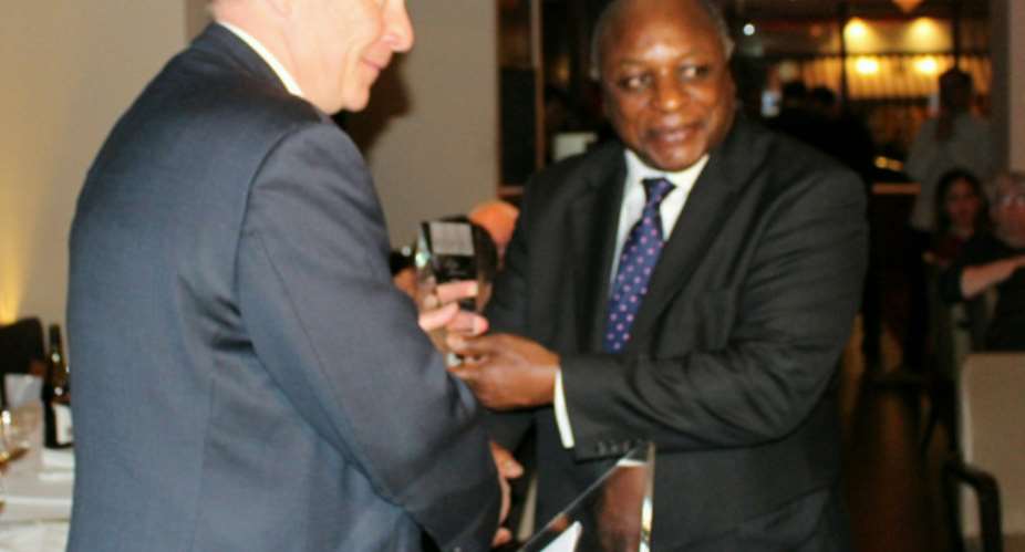 On behalf of HRNJ-Uganda, Henry Gombye receives Lord Astor Award from Lord Guy Black.