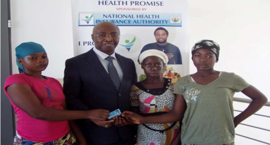 Mr Nathanial Otoo with some of the head porters after they were issued with the NHIS cards