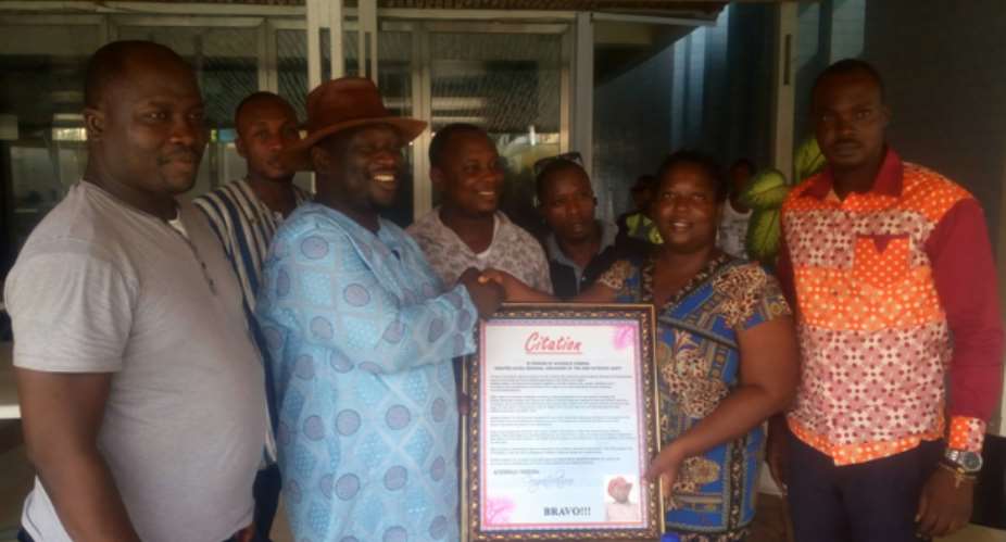 Mr. Archibold Cobbina Receiving the Citation from the Group