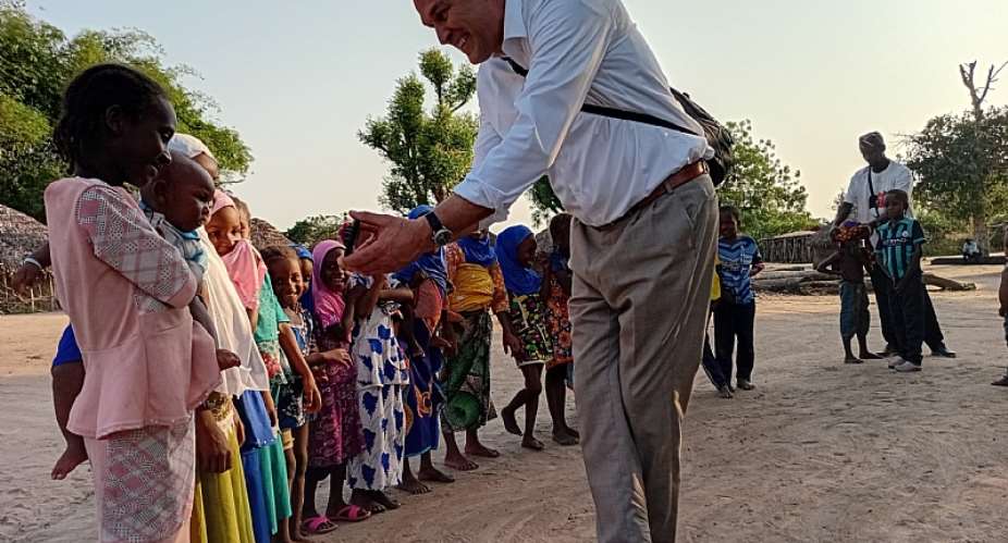 Dr David Tomlinson interacting with some children at Sulleykope in Adaklu District of the Volta Region during an outreach and sensitisation exercise with the a team Friends of Adaklu.