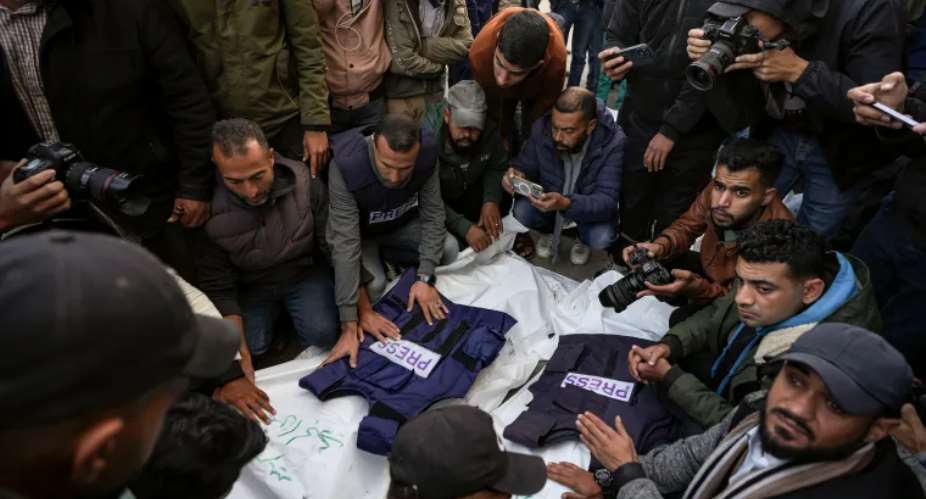 Journalists and other mourners gather around the bodies of four Palestinian journalists and a media worker killed by an Israeli airstrike in Gazas Nuseirat refugee camp on December 26, 2024. (Photo: AP/Abdel Kareem Hana)