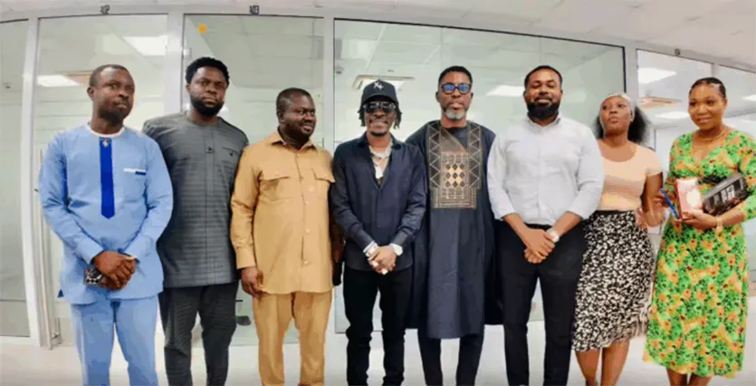 Shatta Wale (M) in a pose with A Plus (4th R) and others