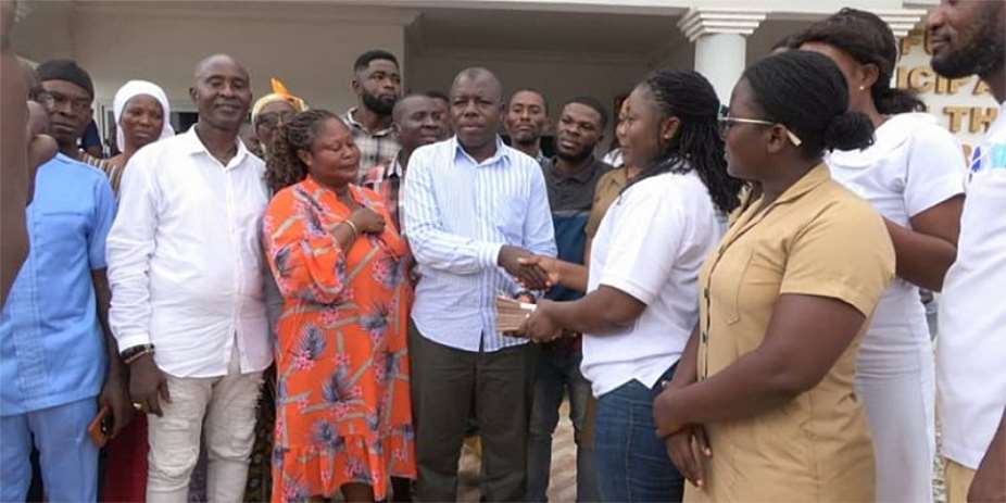 Alhaji Kassim presenting the money to the directorate