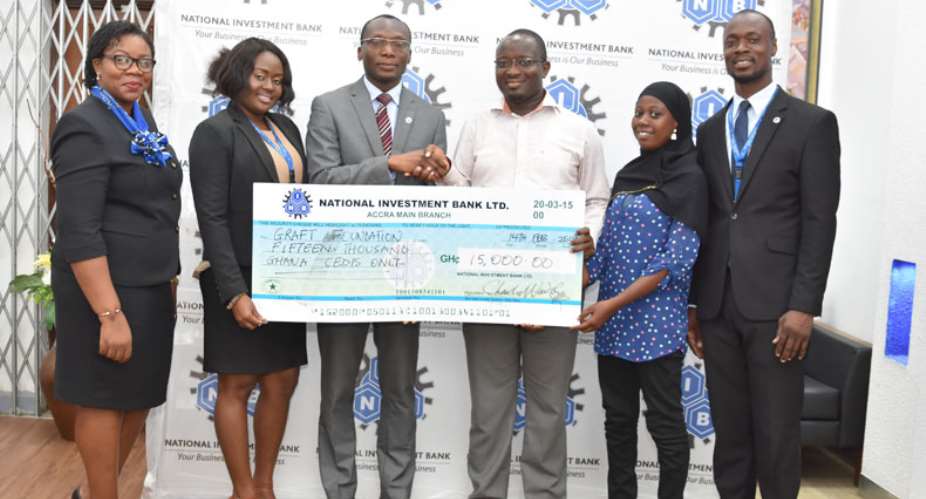 Charles Wordey middle presents a dummy cheque to Dr Brainerd Anani