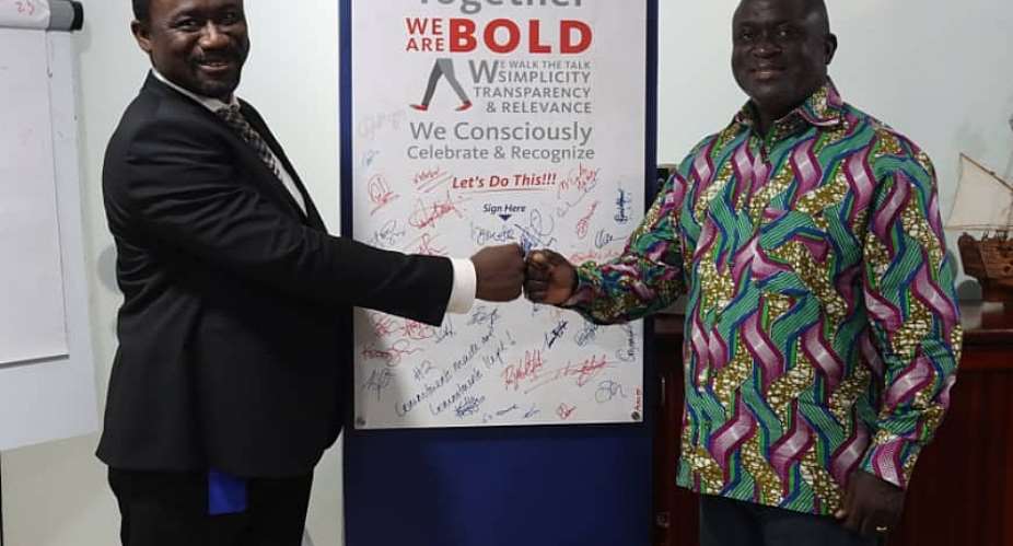 Hon. Adjei Tawiah  right in a handshake with the AirtelTigo Ag. Boss, Mr. Emmanuel Adjei