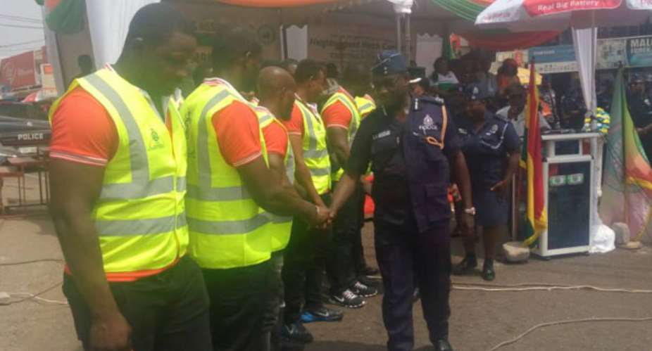 DCOP George Mensah and other senior police officers congratulating members of the Circle Neigbourhood Watchdog Committee