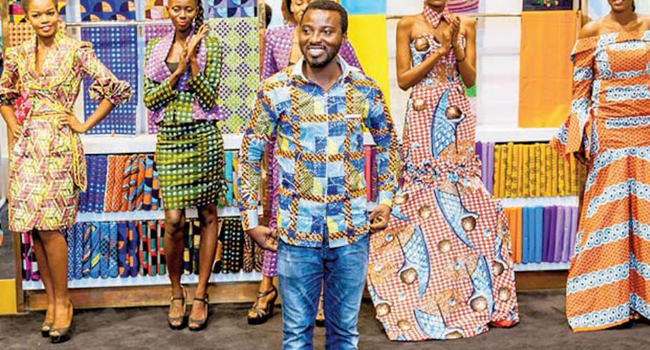 Samson with the model showcasing the new capsule collection at the Vlisco Shop at the Accra Mall in Accra