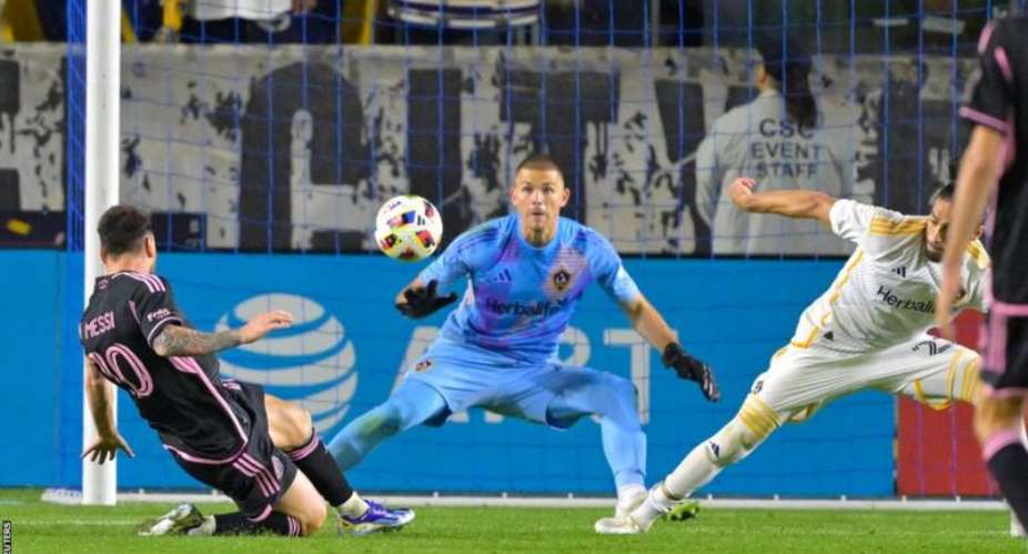 Lionel Messi stabs his shot past LA Galaxy goalkeeper John McCarthy