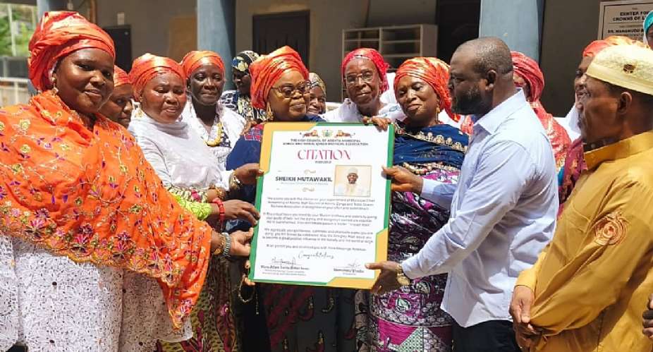 Adentan Municipal Chief Imam receiving the citation from the High Council of the Adenta Municipal Zongo and Tribal Queen Mothers Association