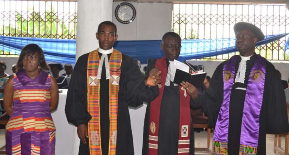 Rev Daniel Amoako Nyarko 2SUPndSUP right praying for Rev Maxwell Johnson Obodai Sai 2SUPndSUP left with Rev Philip Anna-Nai rendering supports. With them is Mrs Obodai Sai