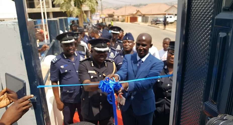 DCOP Frederick Adu Anim being assisted by Francis Kwesi Nyankson to commission the four-bedroom apartment for personnel of ACP Police Station