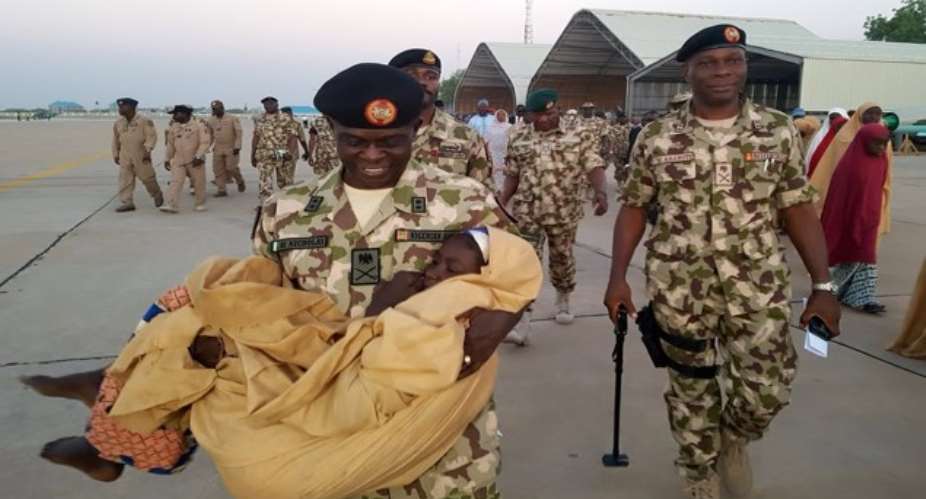 At Maiduguri airport, military and government officials supervise airlift of girls rescued from Boko Haram