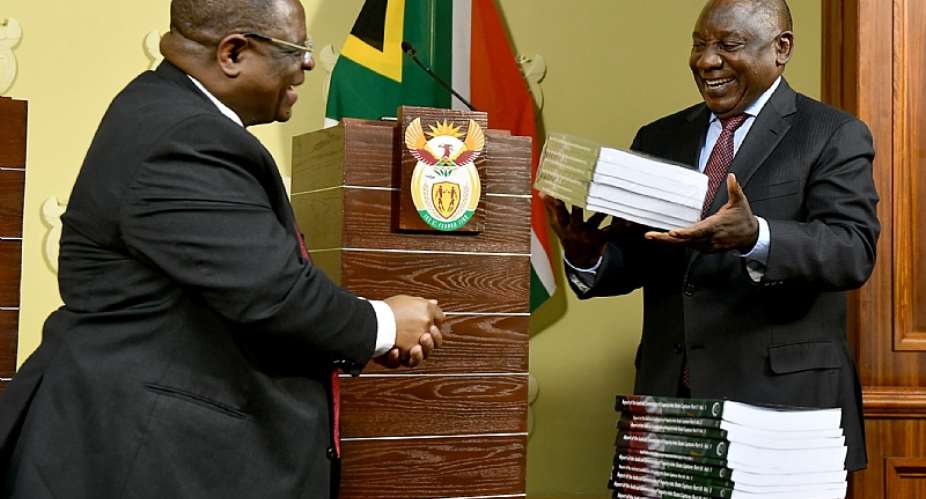 South African President Cyril Ramaphosa receives reports of the of the state capture commission from Justice Raymond Zondo. The reports found exposed massive state corruption involving private individuals and companies.  - Source: GCIS