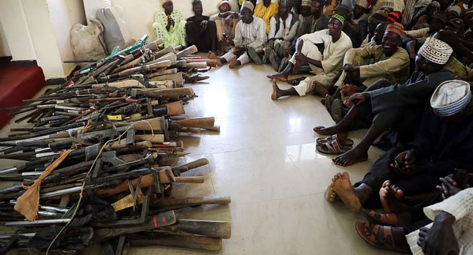 A stash of Kalashnikovs and locally made hunting rifles surrendered by a local vigilante group in Zamfara State, northwest Nigeria.  - Source: Photo by Kola SulaimonAFP via Getty Images