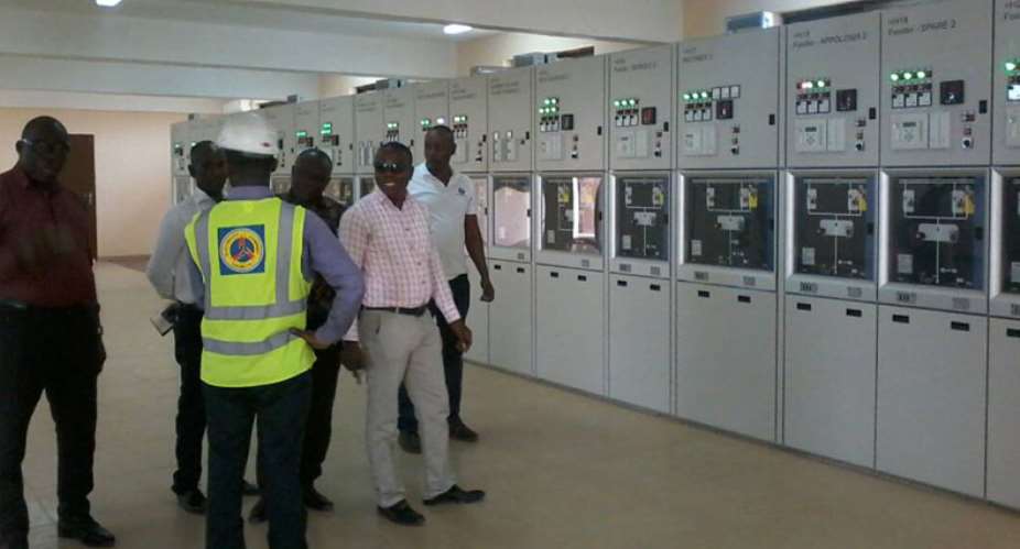 Some officials of ECG inspect the engine room of the new facility