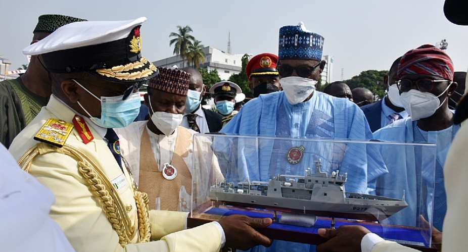 President Buhari receiving a model of NNS OJI from Vice Admiral Awwal Gambo, Chief of the Naval Staff