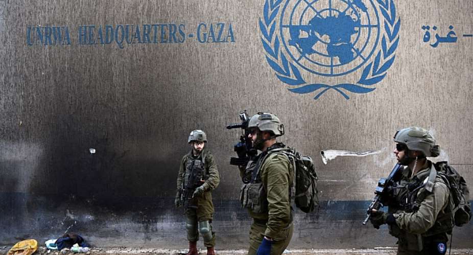 Israeli soldiers operate next to the UNRWA headquarters, amid the ongoing conflict between Israel and the Palestinian Isla...