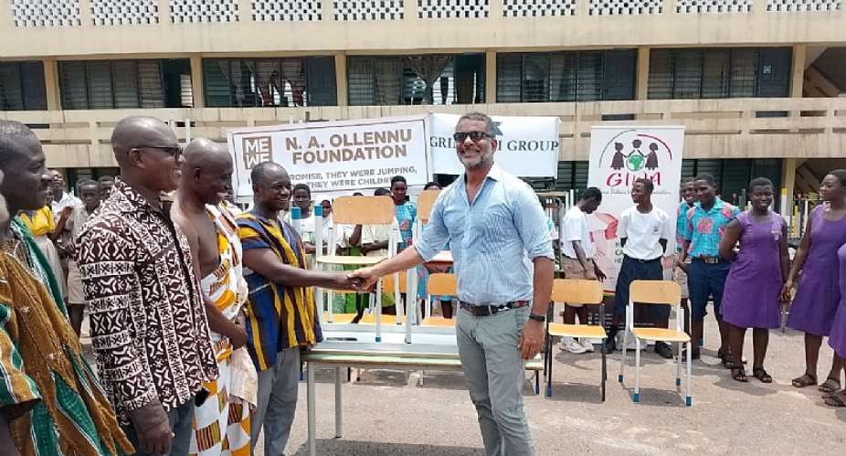 Nii Amaa Ollennu presenting the items to Mr Emmanuel Kwasi Asamoah, Municipal Coordinator of Nzema East