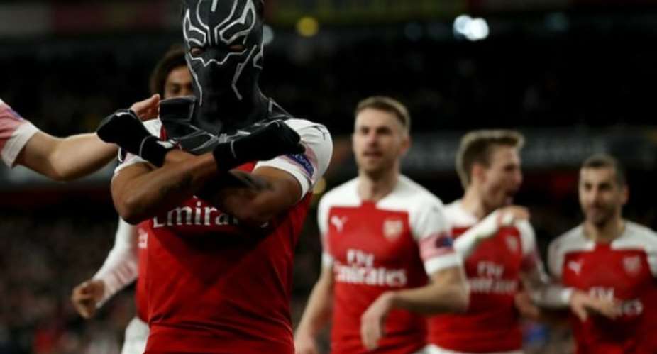 Arsenal's Pierre-Emerick Aubameyang celebrates scoring their third goal wearing a Black Panther mask. Photograph: Shaun BrooksAction Plus via Getty Images