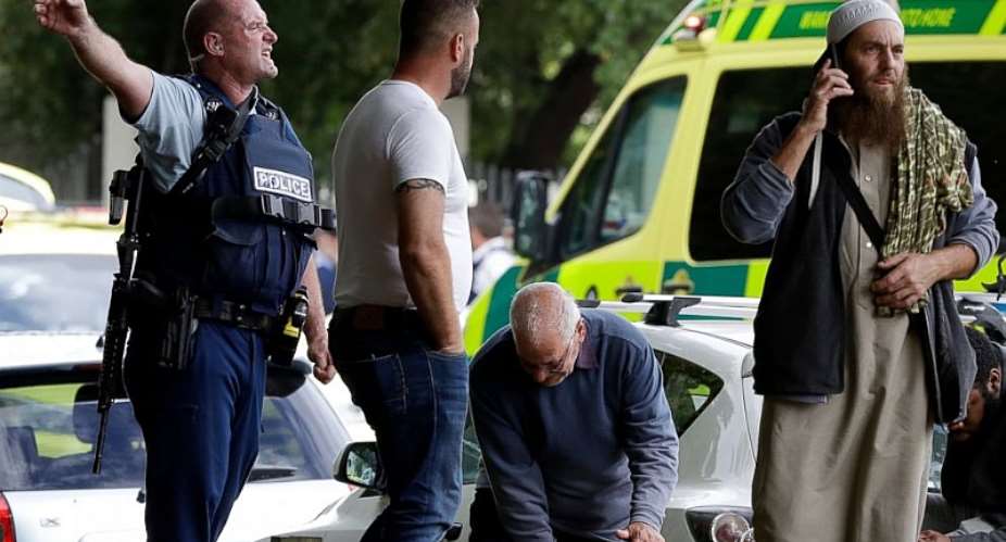 Police attempt to clear people from outside a mosque in central Christchurch, New Zealand