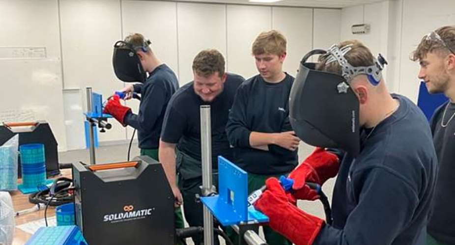 A group of students learning how to weld with welding simulators