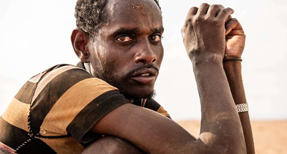 Omar, an Ethiopian migrant, is treated for dehydration and exhaustion by IOM’s Mobile Unit in the Djiboutian desert. Chances of survival are low for migrants crossing the desert in extreme temperatures and the weakest are often left behind. Photo: IOM 2020/Alexander Bee