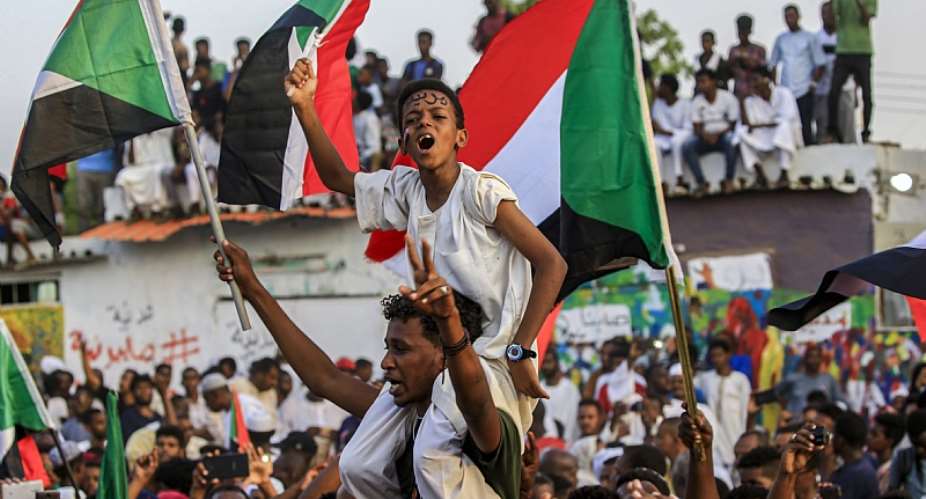 Sudanese protestors celebrate a deal with the ruling generals on a new governing body, in the capital Khartoum, recently.  - Source: Ashraf ShazlyAFP via Getty Images