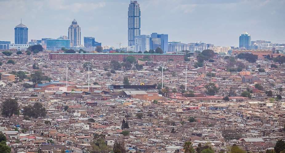 South Africaamp;39;s Alexandra township in the foreground, where the  majority live in squalor, and Sandton in the background, representing the most privileged  - Source: Shutterstock