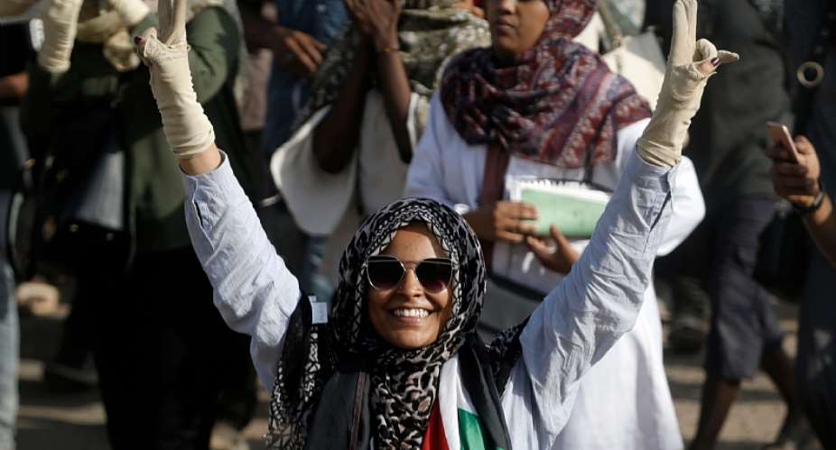 A woman flashes the V for victory sign as Sudanese protesters demonstrate in Khartoum on July 25, 2019. - Source: Ashraf ShazlyAFP via Getty Images