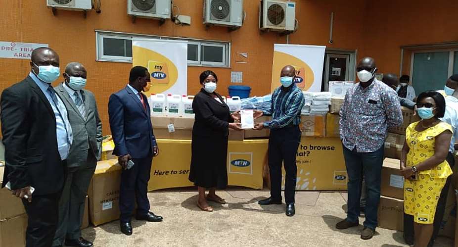 Dir of Nursing Services at KATH, Madam Georgina Afua Sam receiving the items from Nii Adotey Mingle, General Manager MTN Northern Business District
