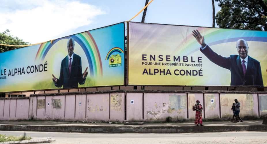 A sign depicting President Alpha Conde during his reelection campaign is seen in Conakry, Guinea, on October 12, 2020. Journalist Amadou Diould Diallo has been detained for allegedly insulting the president. AFPJohn Wessels