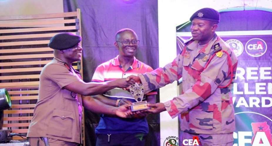 ZAKARIA KABORE RIGHT RECEIVING HIS AWARD FROM THE REGIONAL FIRE OFFICER