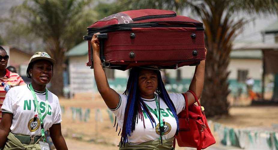 A National Youth Service Corps member leaves the orientation camp in Kubwa, Abuja, following an order by the Nigerian government to curb the spread of the COVID-19.  - Source: Kola SulaimonAFP via Getty Images