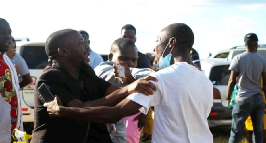 Courage Dutiro right, a journalist for the Zimbabwean newspaper TellZim, was slapped and manhandled by a bodyguard after taking pictures when a candidate collapsed at a political rally. Open Parly