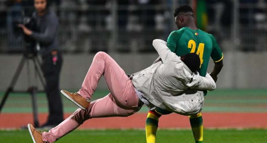 PHOTOS: Fan rugby tackles player, mass pitch invasion as Ivory Coast v Senegal friendly abandoned