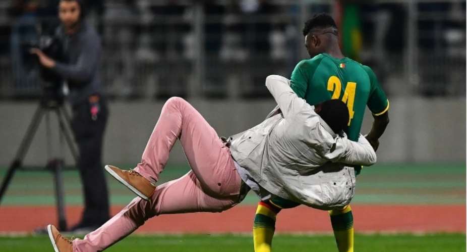 Ivory Coast vs Senegal friendly cancelled after supporters invade the pitch, chase players and tackle Lamine Gassama