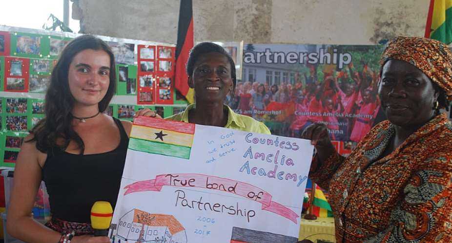 Miss Laura and Rev Grace Dodoo R displaying the poster