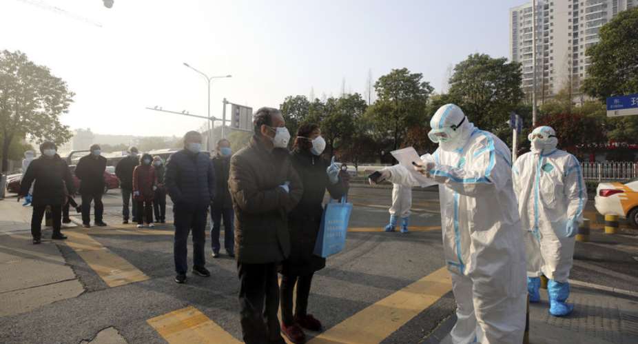 People in Wuhan, China, line up at a facility that tests discharged COVID-19 patients as well as individuals who had been held in isolation. Source: Getty Images