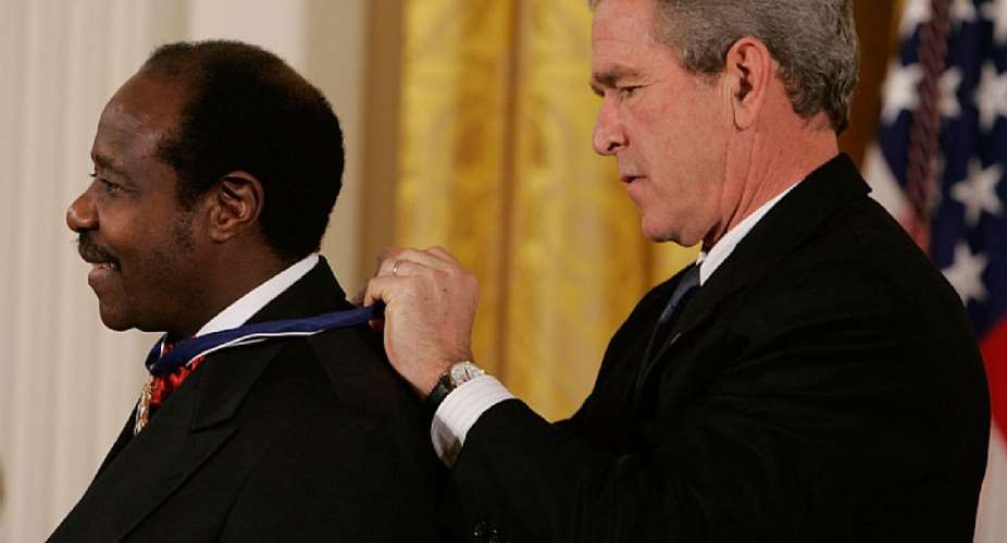 Paul Rusesabagina receives the Medal of Freedom from US President George W Bush in 2005.  - Source: Mark WilsonGetty Images