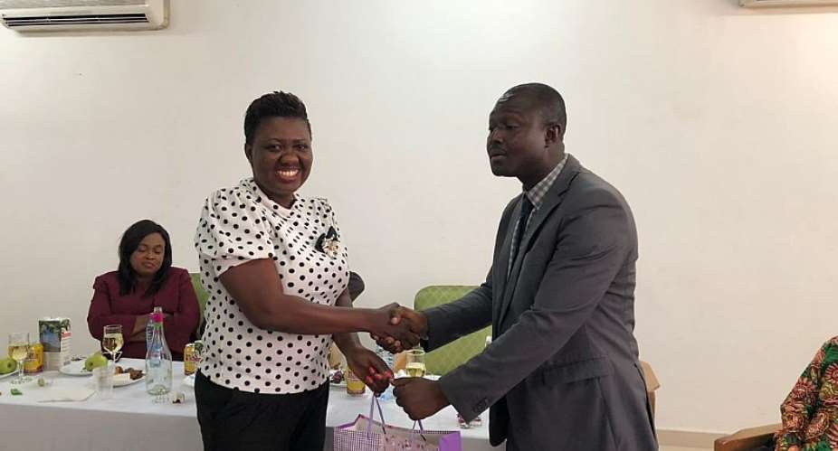 Dr. Poku Adusei, Outgoing Deputy Director General in charge of General Services DDG-G, being presented with a gift from the Authority
