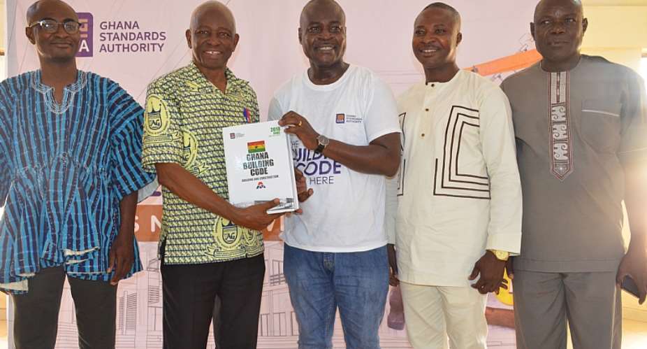 Prof. Dodoo, Director-General of the GSA middle, presenting the first copies of the Code to Prof. Abole, MCE of the Bolga East District Assembly