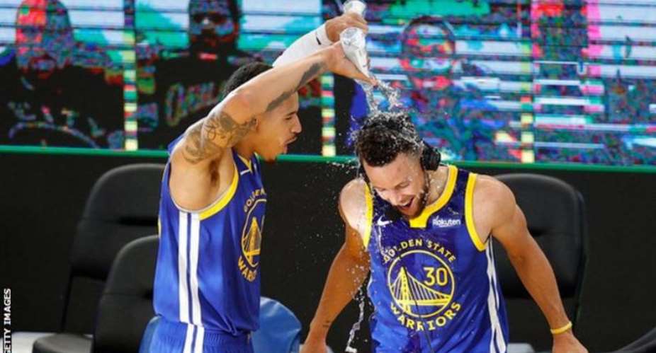 Stephen Curry was soaked by fellow Warriors player Juan Toscano-Anderson after the win